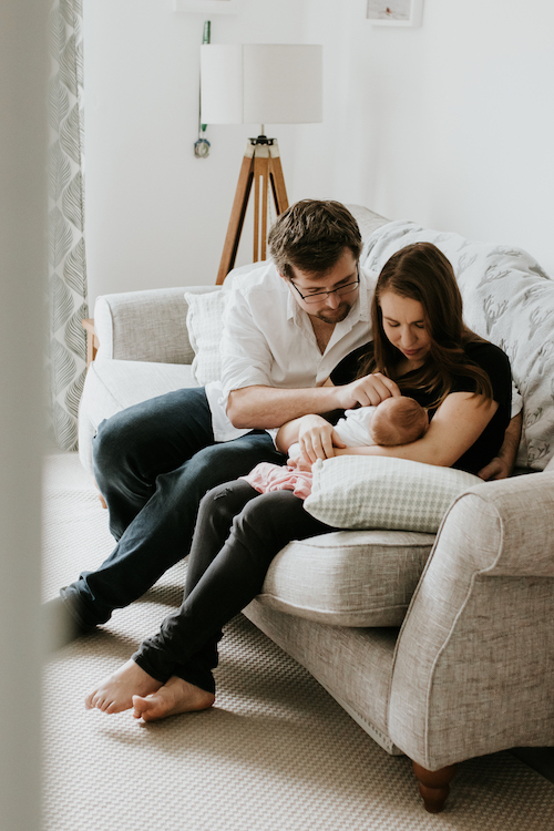 Mum, dad and baby in their living room | at home newborn photoshoot