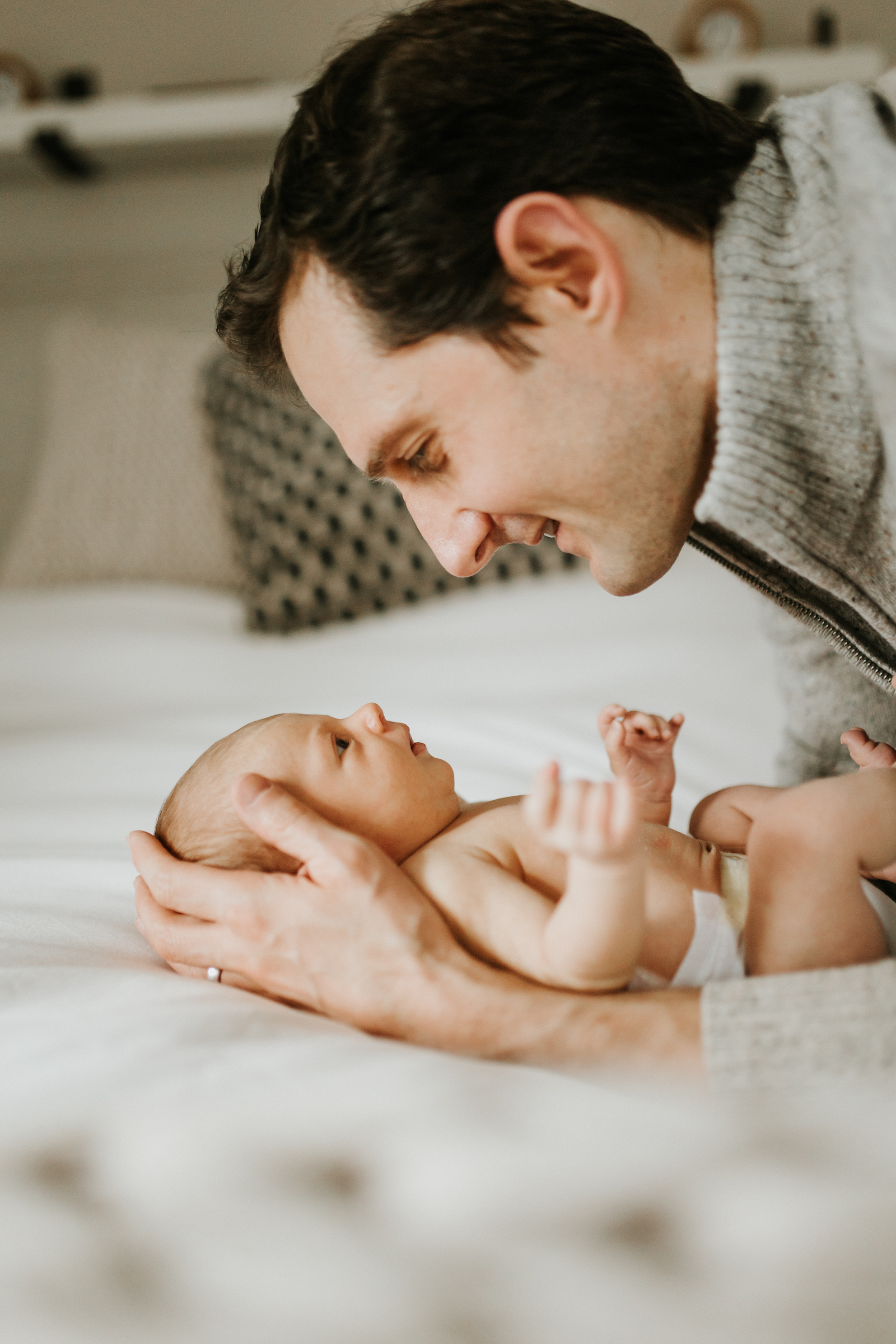 Dad holding newborn baby head in his hands | beautiful in-home storytelling newborn session