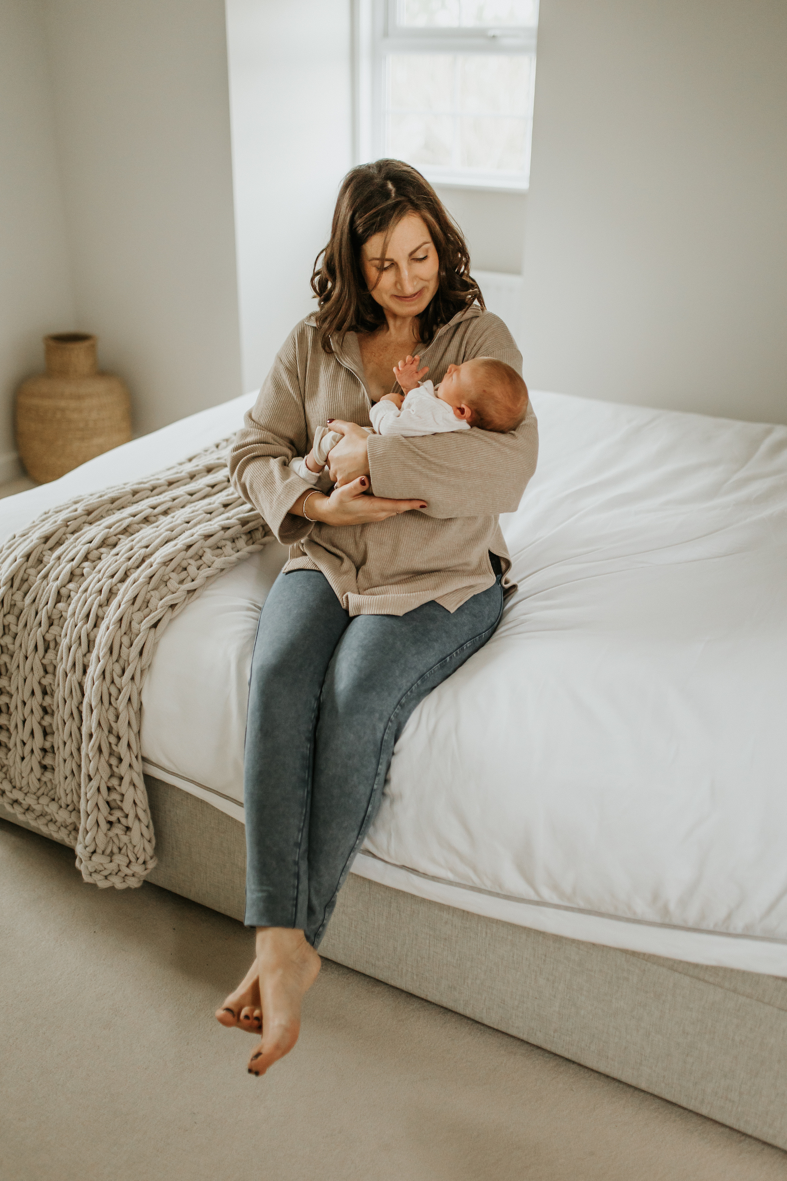 Mum holding newborn baby in her arms | beautiful in-home storytelling newborn session